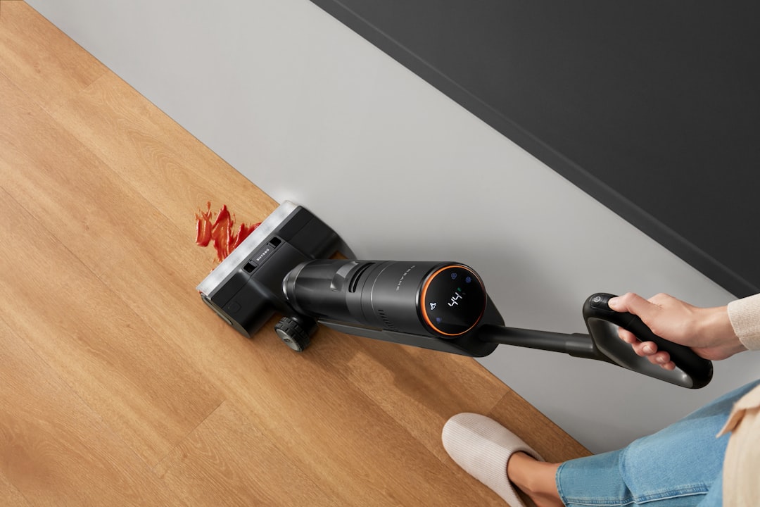 A Dreame wet dry vacuum cleans a tomato sauce spill along the wall for quick, reliable cleanup in busy households.